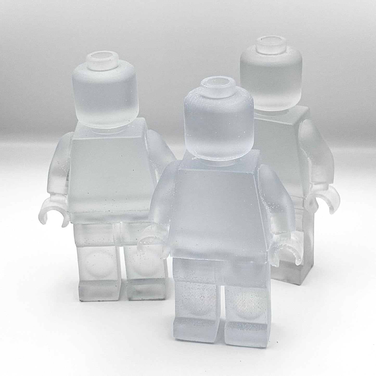 3 lego man sculpture side by side